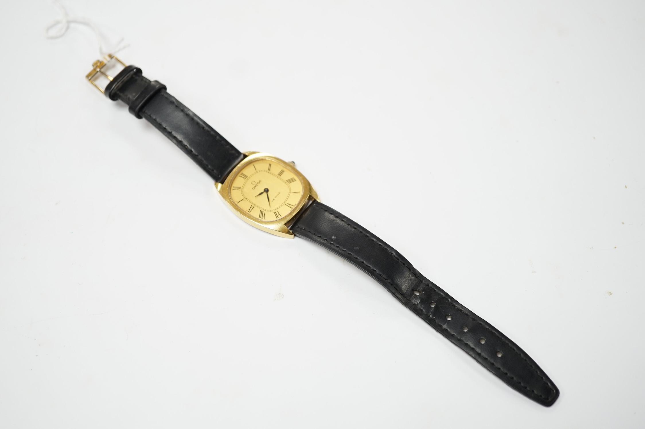 A gentleman's steel and gold plated Omega De Ville manual wind dress wrist watch, with oval Roman dial, on a leather strap, with gold plated Omega buckle, case diameter 30mm, no box or papers. Fair condition.